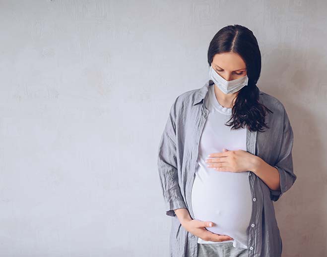 pregnant woman wearing mask